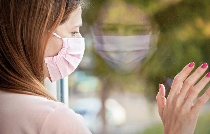 Young,Woman,In,Pink,Virus,Mask,Looking,Sad,From,The Are You at Risk for Post-COVID Stress Disorder?
