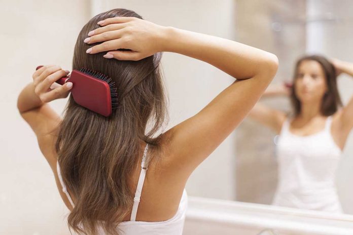 Young,Woman,Brushing,Healthy,Hair,In,Front,Of,A,Mirror Minor Inconvenience or Major Health Problem? Don't Miss THESE Signs