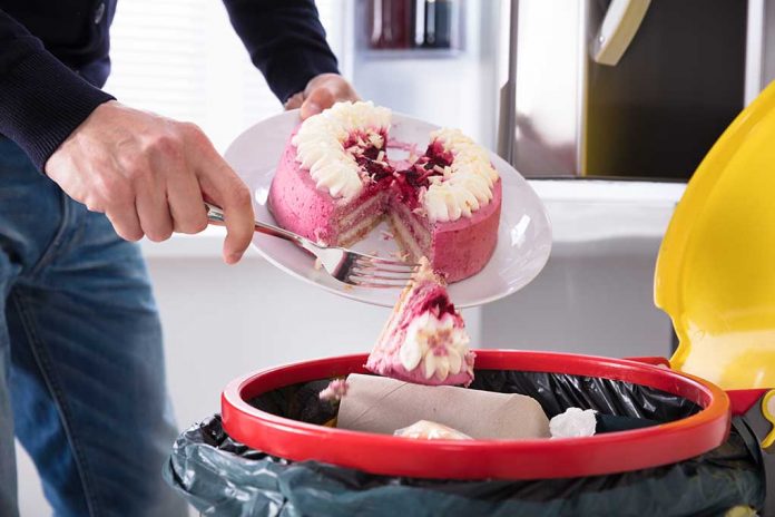Close-up,Of,A,Human,Hand,Throwing,Cake,In,Trash,Bin 8 Ways to Cut Down on Food Waste & Save Money Too