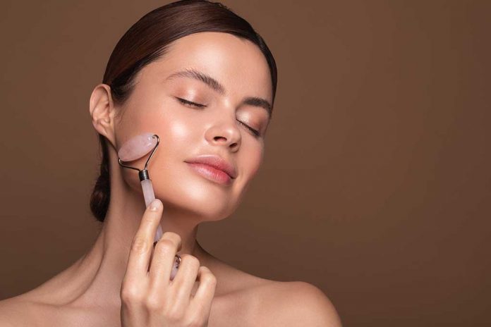 Relaxed,Young,Woman,Standing,Isolated,On,The,Brown,Background,And Do Face Rollers Work? Experts Weigh In