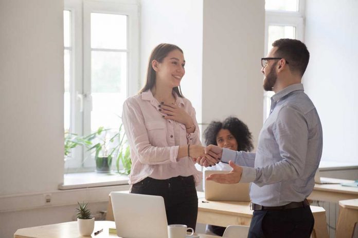 Male,Boss,Congratulating,Female,Employee,Handshaking,And,Greeting,Her,On How to Look & Feel Better By Giving Genuine Compliments