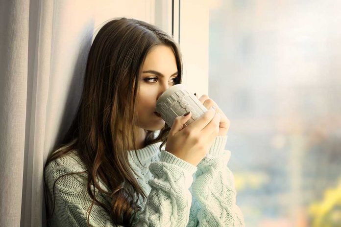 Woman,Drinking,Coffee,Near,Window,In,The,Room Could Drinking THIS Lower Your Risk of Liver Disease?