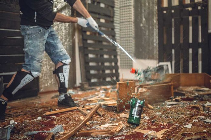 A,Man,Smashing,The,Bottle,With,Golf,Club All the Rage or a Recipe for Disaster: A Closer Look at Rage Rooms
