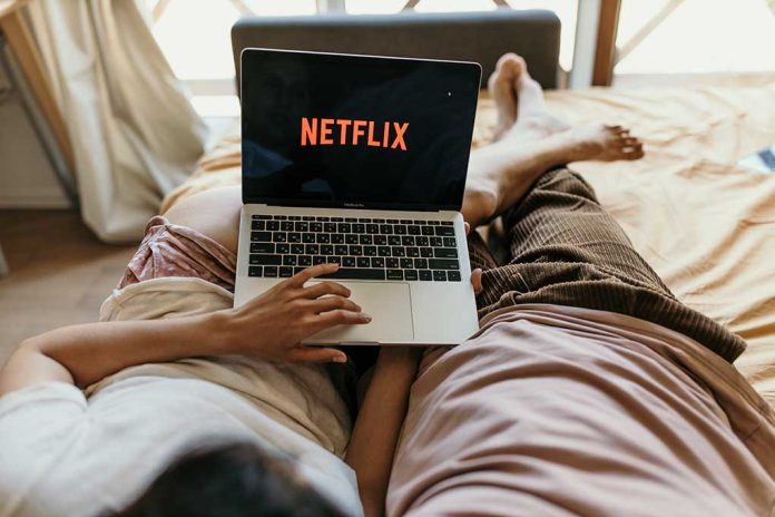 Couple,Laying,In,Bed,And,Watching,Netflix.,Skopje/macedonia/10/06/2020 Netflix and Chill Safely: Binge Watching Risks (and Some Surprising Benefits)