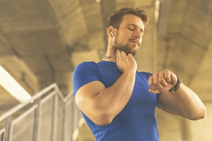 Young,Sportsman,Measuring,Pulse,And,Heart,Rate,During,Workout. What Your Resting Heart Rate Says About Your Future