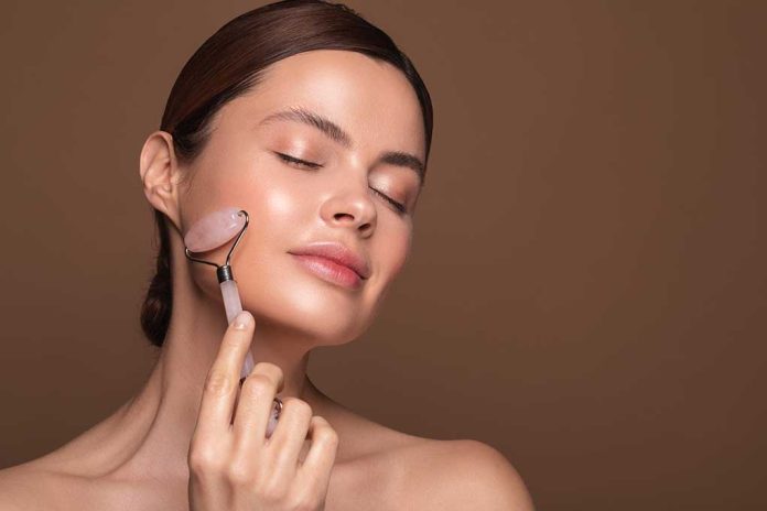 Relaxed,Young,Woman,Standing,Isolated,On,The,Brown,Background,And Do Face Rollers Work? Experts Weigh In