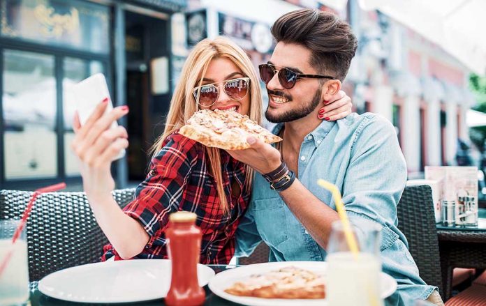 Dating,In,Pizzeria.,Young,Smiling,Couple,Enjoying,In,Pizza,,Having Could Your Smartphone Make You Gain Weight?